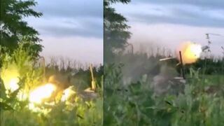 Ukrainian serviceman strikes a Russian armoured fighting vehicle