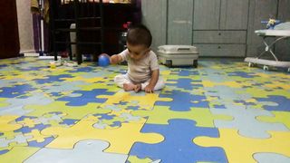 Cute baby is playing with his father