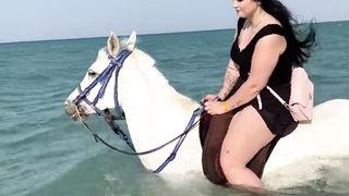 ENJOYING HORSE RIDING IN SEA.