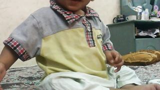 Cute baby was speaking with his grandmother