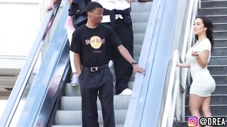 TOUCHING HANDS ON THE ESCALATOR