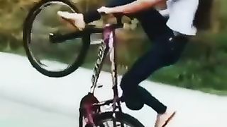 Girl doing stunts on a bike