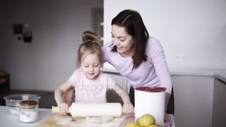 Butiful young and little girl cooking