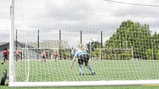 Young children dribbling a soccer