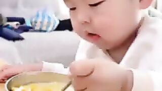 baby eating egg