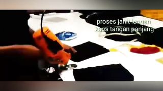 The process of sewing the sleeves of a T-shirt