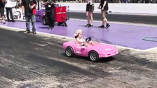 Little Girl Doing Burnouts in Toy Car