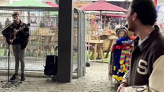 a street preformance meets the singer of the song which he was singing