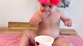 baby makes a huge mess with strawberry yogurt