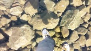Walking on an amazing crystal clear frozen lake in the High Tatras Mountains, Slovakia.