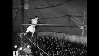 Charlie_Chaplin_cycling_down_a_tightrope