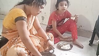 Indian mother and daughter eating food