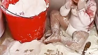 cute baby playing with flour