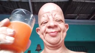Bald wrinkly guy drink orange juice moan