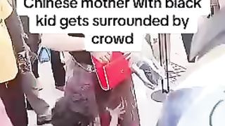 CHINESE MOTHER WITH BLACK KID