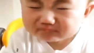 the boy is eating a lemon