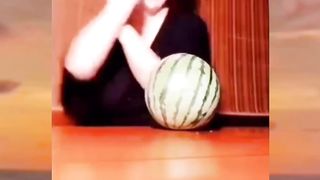 This woman is breaking a watermelon with her breasts