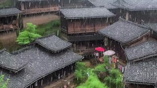 heavy rain in town with foggy high green mountains