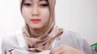 Wanita jilbab buka baju depan kamera