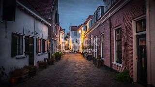 Illuminated old town street in Amersfoort at dusk - Netherlands