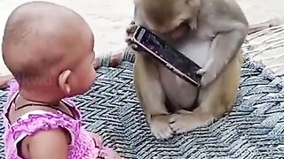 Baby and monkey playing mobile