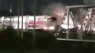 video of the truck breaking down in the middle of the railroad tracks.