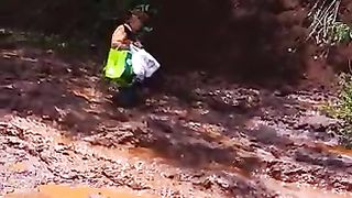 An elderly woman hopelessly stuck in the mud,