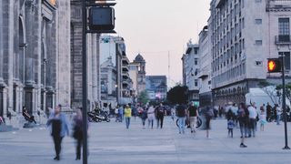 Street with people walking at dusk