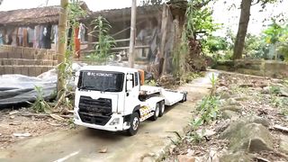 Tronton truck, long trailer, remote control, full of bricks passing through the road and scenery
