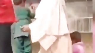 Women help children to drink water