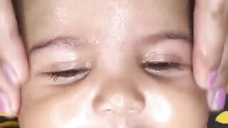 Cute baby enjoying the face massage