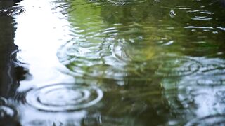 Rain falling in water relaxing