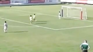A boy played football but missed the empty goal