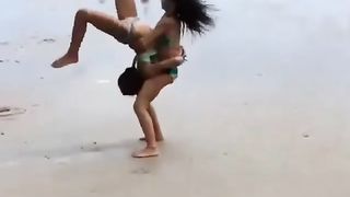 Two beautiful women playing by the seaside
