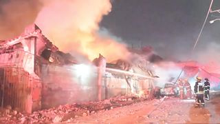 Firefighters tackle a blaze after an explosion in a Dominican shop  AFP