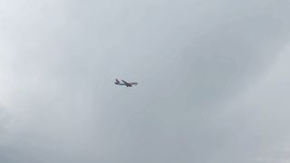 An Airliner Flying Across a Cloudy Sky