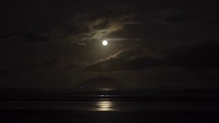 Time Lapse Of a Full Moon Rising Over The Ocean