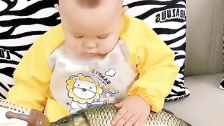 Baba is feeding the fish in his feeder while woo  .
