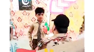 A little boy is giving the flag of pti to army