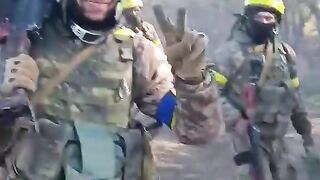 Ukrainian soldiers walking with guns