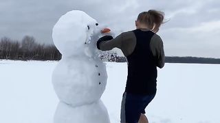 Beautiful girl playing with ice in cold water