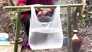 women cooking fish in platic bag