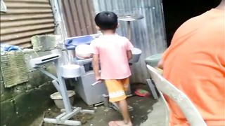 A small child plays the Guns and Roses drum song from makeshift equipment
