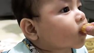 Little boy eating orange cute ????