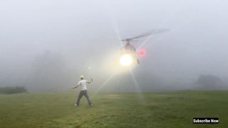 Man Extremely Close To An AS 350 Helicopter Landing In Thick Fog