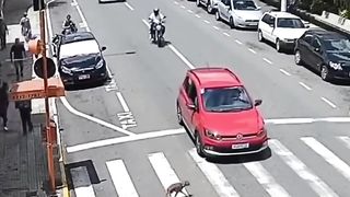 Motorcycle Crashes into Car in Busy Street