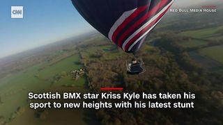 Kriss Kyle- BMX rider performs tricks on platform suspended from  air balloon