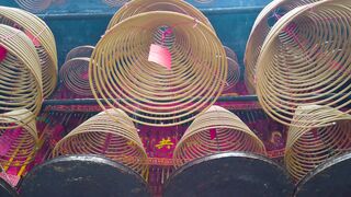 A Burning Spiral Incense Hanging In The Temple