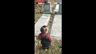 Little girl in cemetery sees waves  and kisses ghost or spirit