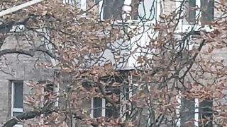 The lovely neighbors opposite began to clean the balcony
